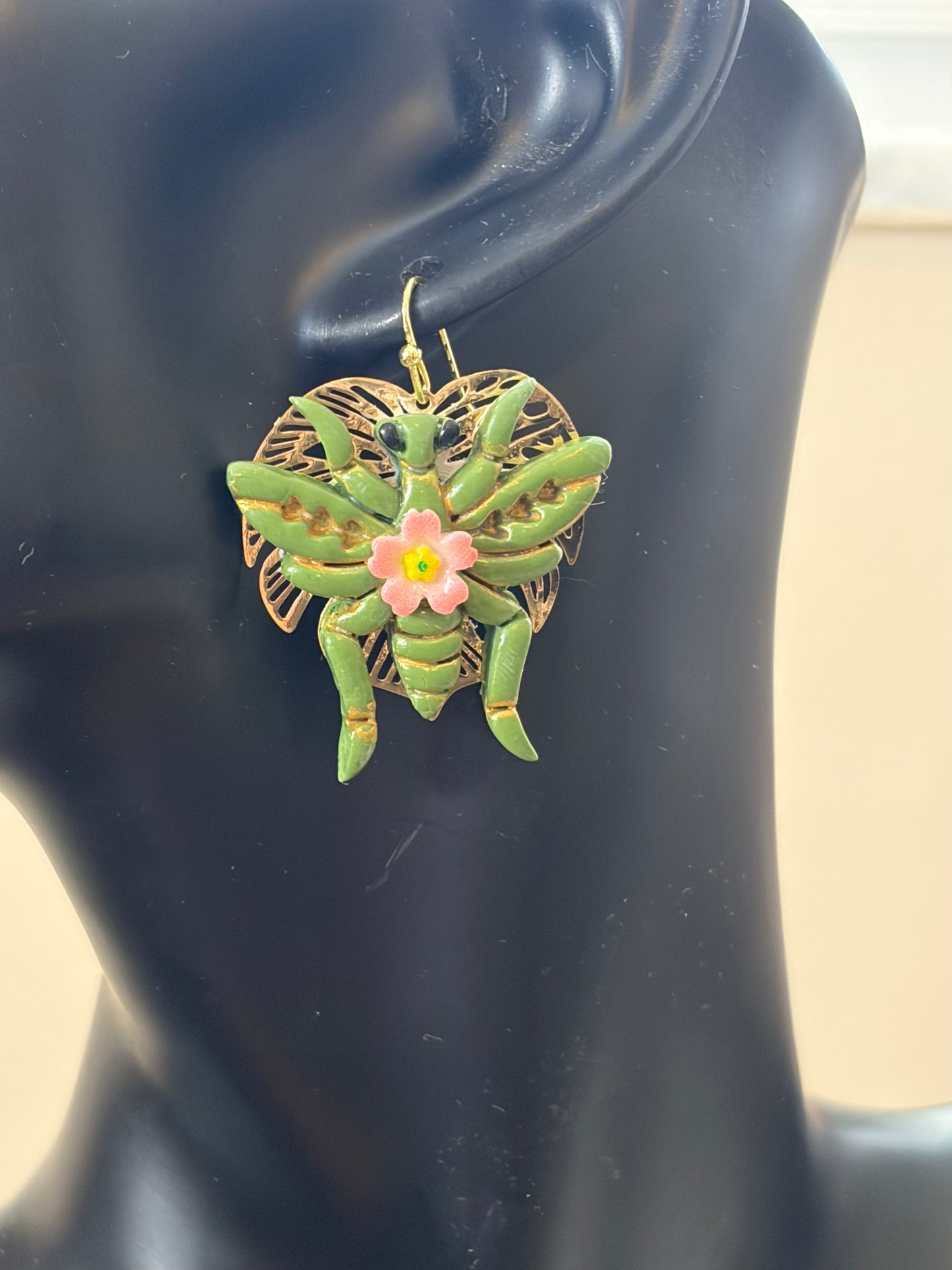 Grasshopper earrings on a leaf